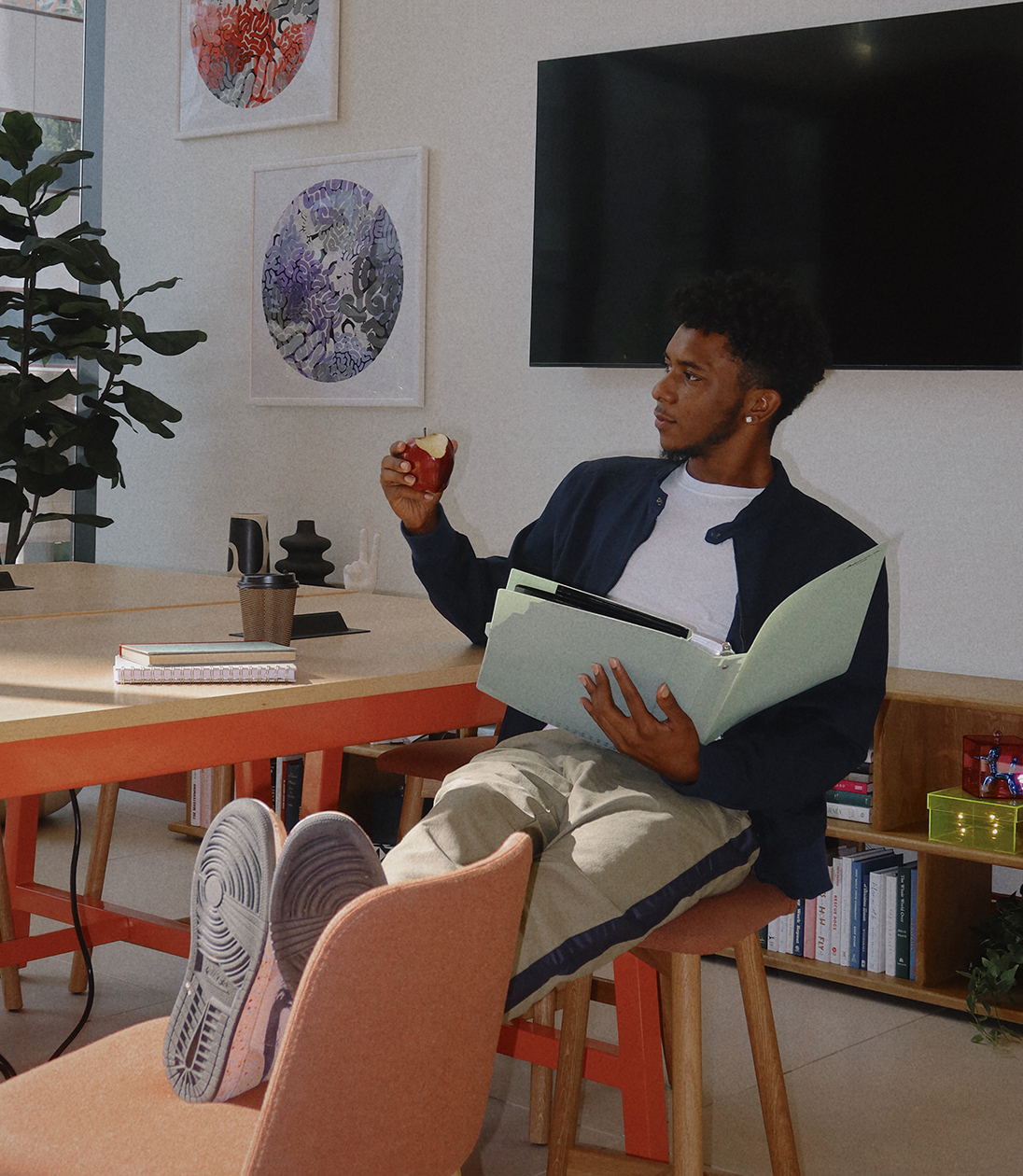 A man sitting down and holding a book